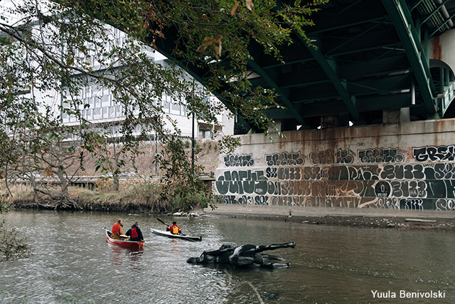 The sculpture is towed by a canoe and kayak up the Don River.